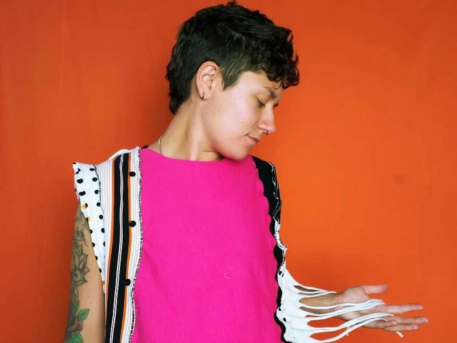 Kayla Burnett wears one of their custom clothing items. Burnett hopes to create a safe space for LGBTQ and non-binary individuals by providing the freedom to explore their identity through art.