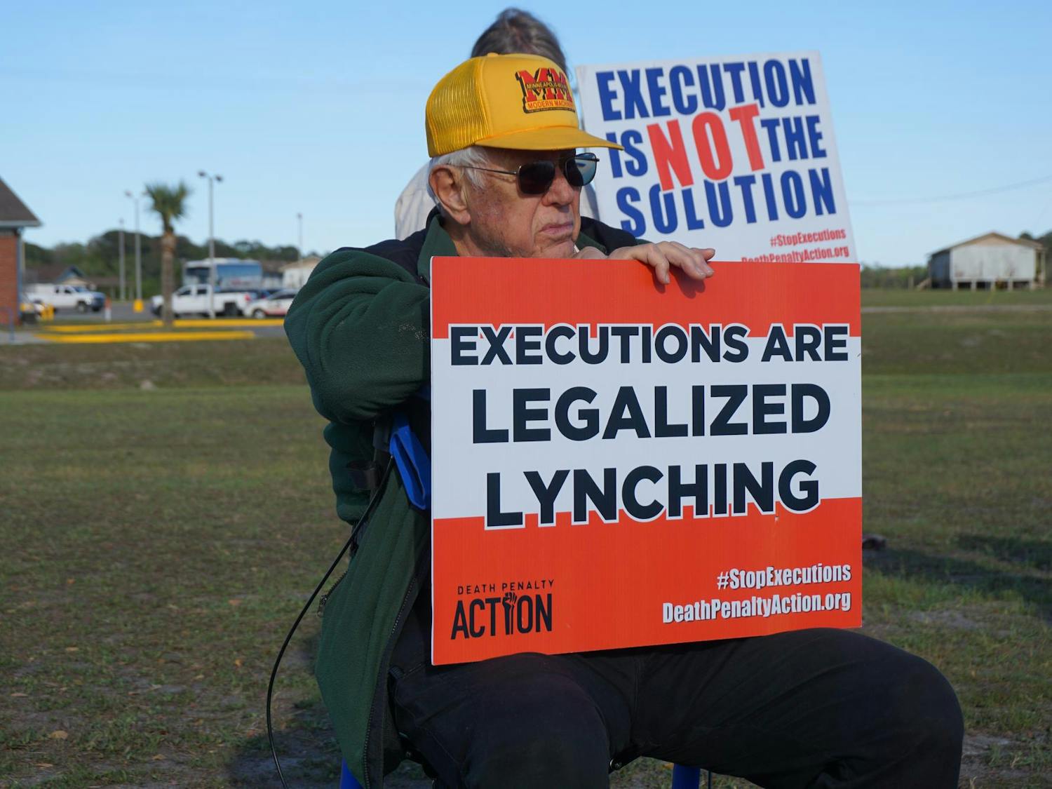 Protesters sit outside praying before the execution of Michael King, Tuesday, March 17, 2026, at Florida State Prison in Raiford, Fla.