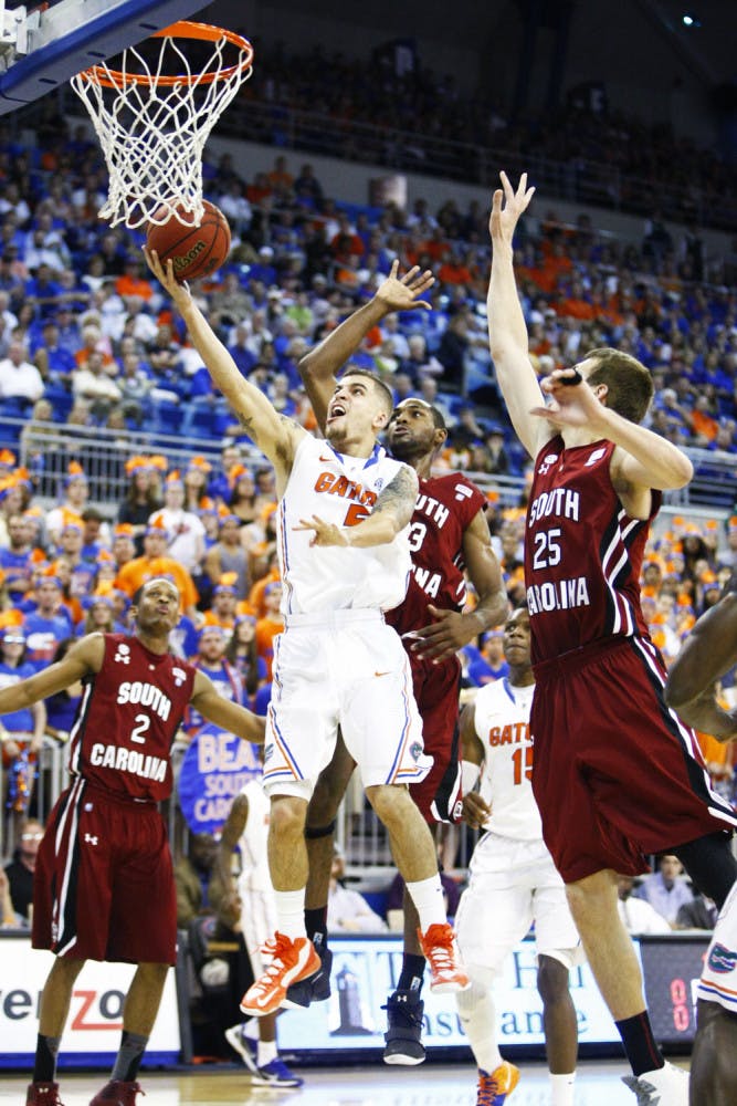 Guard Scottie Wilbekin (5) attempts a layup during Florida’s 75-36 win against South Carolina on Wednesday night in the O’Connell Center.
