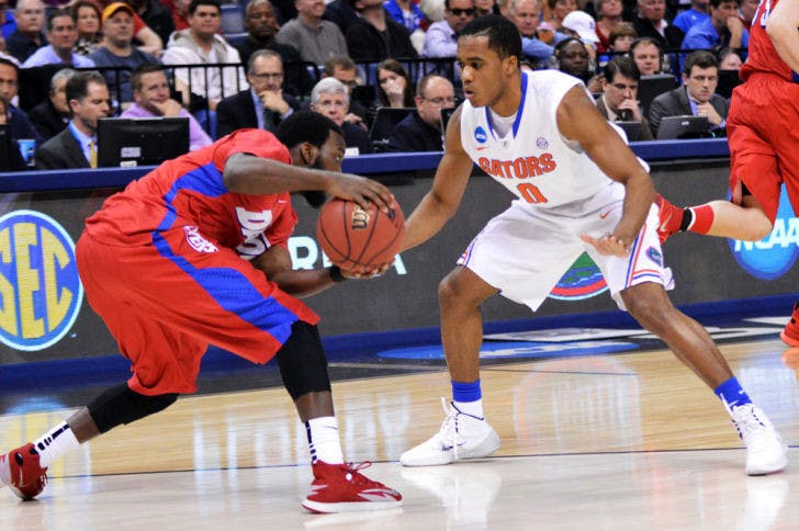 Kasey Hill (0) defends Dayton’s Khari Price during the Gators’ 62-52 win over the Flyers on Saturday in FedExForum in Memphis, Tenn. Hill missed UF’s first game against UConn with an ankle sprain and is currently playing through turf toe.