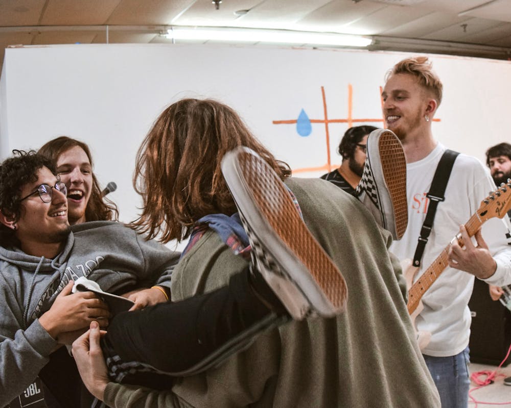 <p>Daniel Villamil crowd surfs at a performance by local punk band The Real You at The Moisturizer Gallery Wednesday, Dec. 11, 2019. </p>