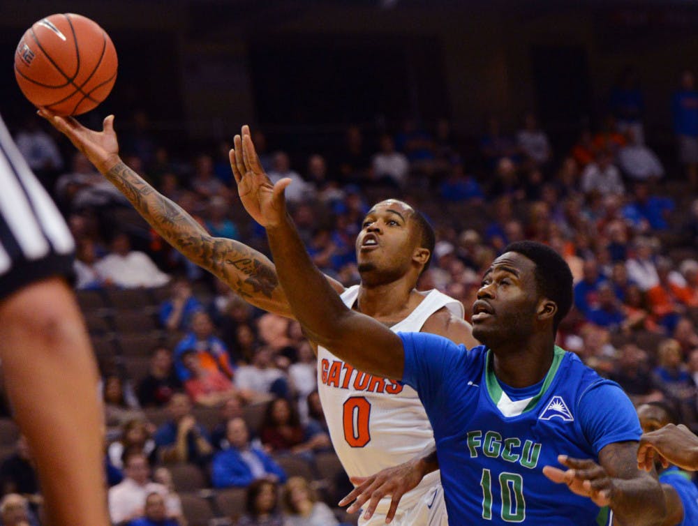 Florida guard Kasey Hill drives to the basket as Florida Gulf Coast forward Kevin Mickle defends during the first half of an NCAA college basketball game, Friday Nov. 11, 2016, in Jacksonville, Fla. (Bob Mack/The Florida Times-Union via AP)