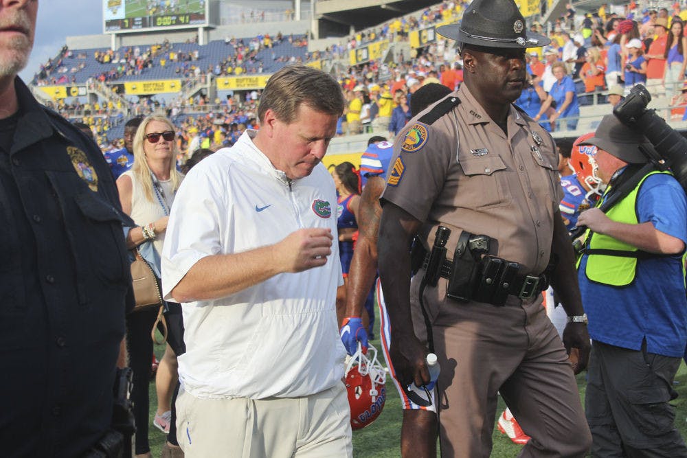 <p>UF football coach Jim McElwain walks off the field following Florida's 41-7 loss to Michigan in the Citrus Bowl on Jan. 1, 2016, in Orlando.</p>