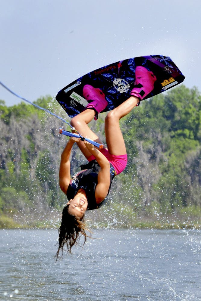 Dixie Smith, a 20-year-old UF biology senior, performs a wakeboard stunt on Lake Wauberg.