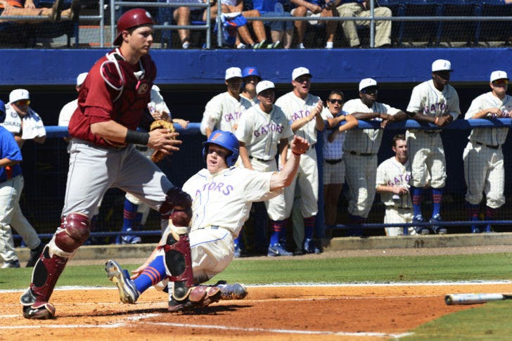 Freshman outfielder Harrison Bader slides into home during Florida's 14-5 win against South Carolina on Saturday. Bader scored a run in the Gators' 7-1 win against the Owls on Tuesday.