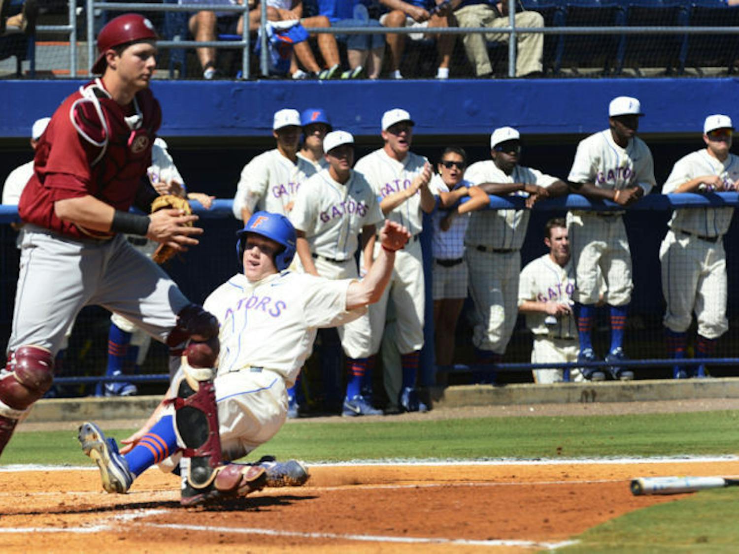 Freshman outfielder Harrison Bader slides into home during Florida's 14-5 win against South Carolina on Saturday. Bader scored a run in the Gators' 7-1 win against the Owls on Tuesday.