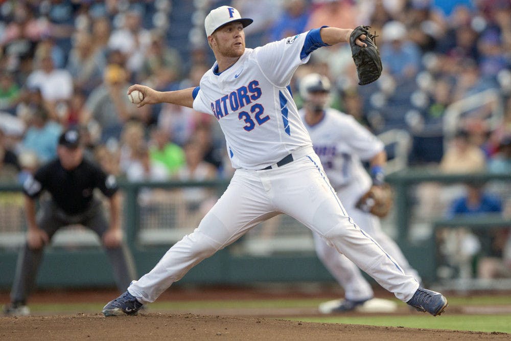 <p>Florida's Logan Shore (32) pitches during the Gators' 15-3 victory against Miami in the NCAA Men's College World Series on Saturday, June 13, 2015 at the TD Ameritrade Park in Omaha.</p>
