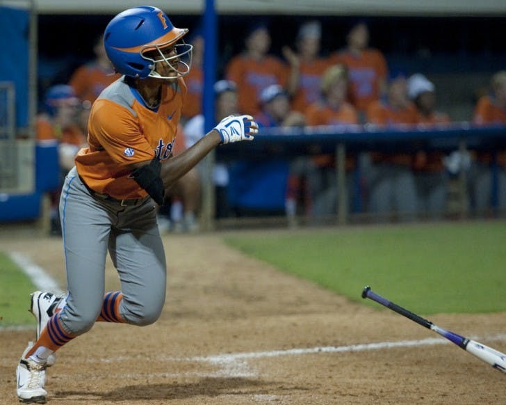 Florida senior outfielder Michelle Moultrie drops her bat to run after recording a hit against USF on March 28. UF has struggled in midweek games as of late.