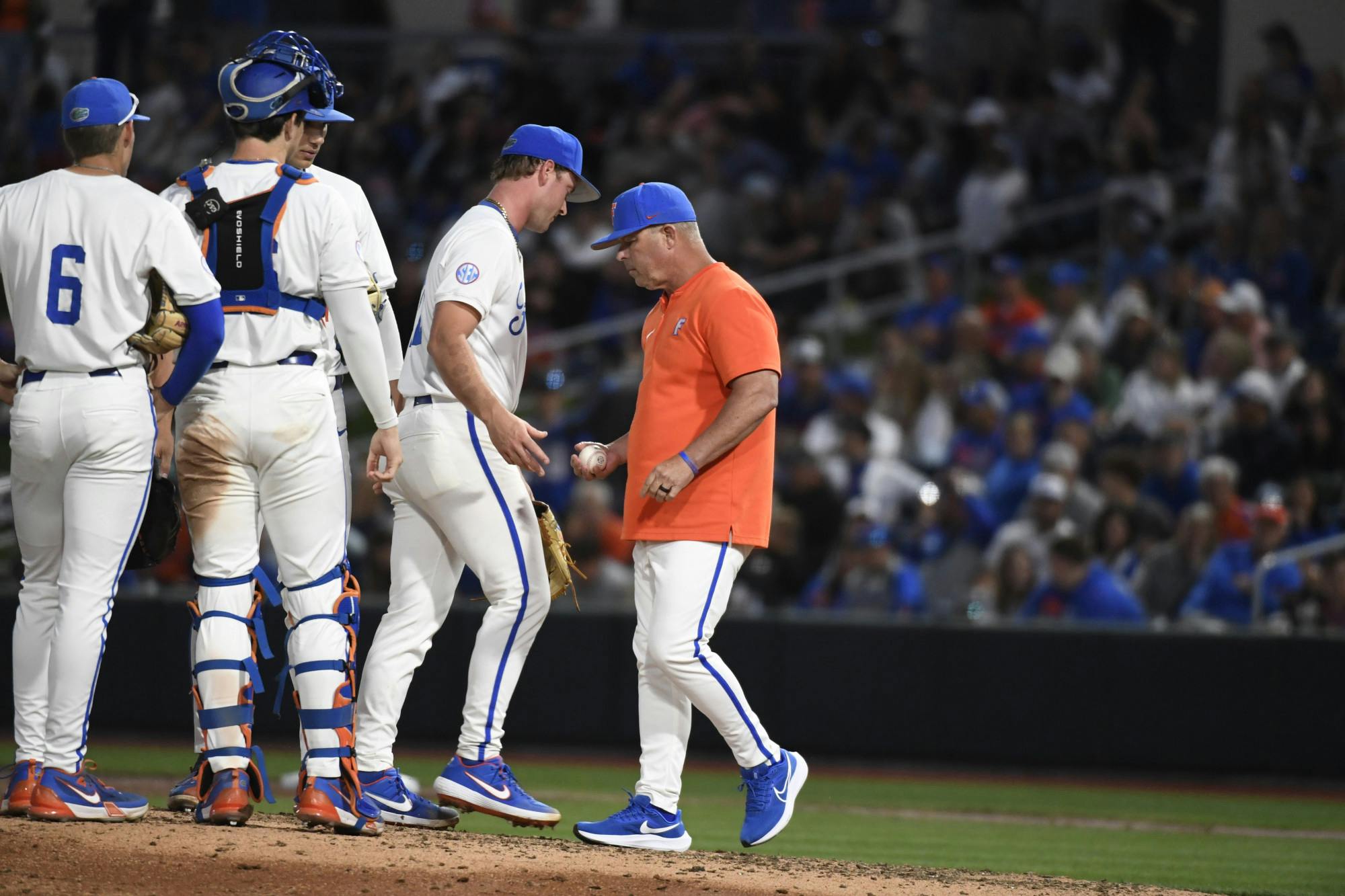Florida baseball head coach Kevin O' Sullivan takes the ball from Brandon Neely in the team's loss to the South Carolina Gamecocks on Friday, April 12, 2024. 