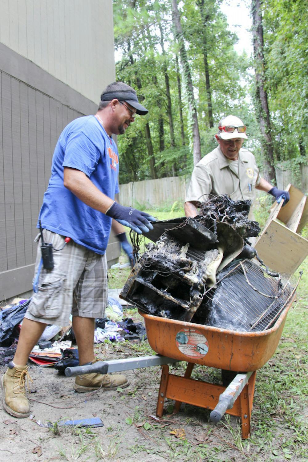 <p class="p1"><span class="s1">The Aspen Companies’ workers Jeremy Dees, left, and Greg Dove, right, clean up damage from a fire at Majestic Oaks Apartments on Tuesday afternoon.</span></p>