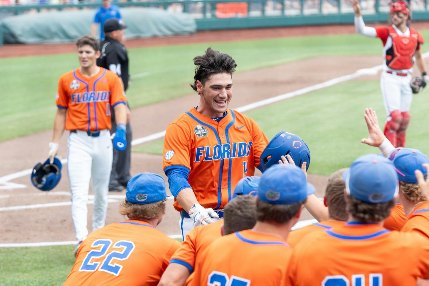 Florida junior two-way star Jac Caglianone celebrates with his teammates after hitting a three-run home run against North Carolina State at the Men’s College World Series in Omaha on Monday, June 17, 2024.