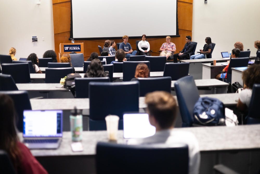 Students talk during a student-hosted debate in Reitz Union’s Senate Chamber on Thursday, Oct. 3, 2024.
