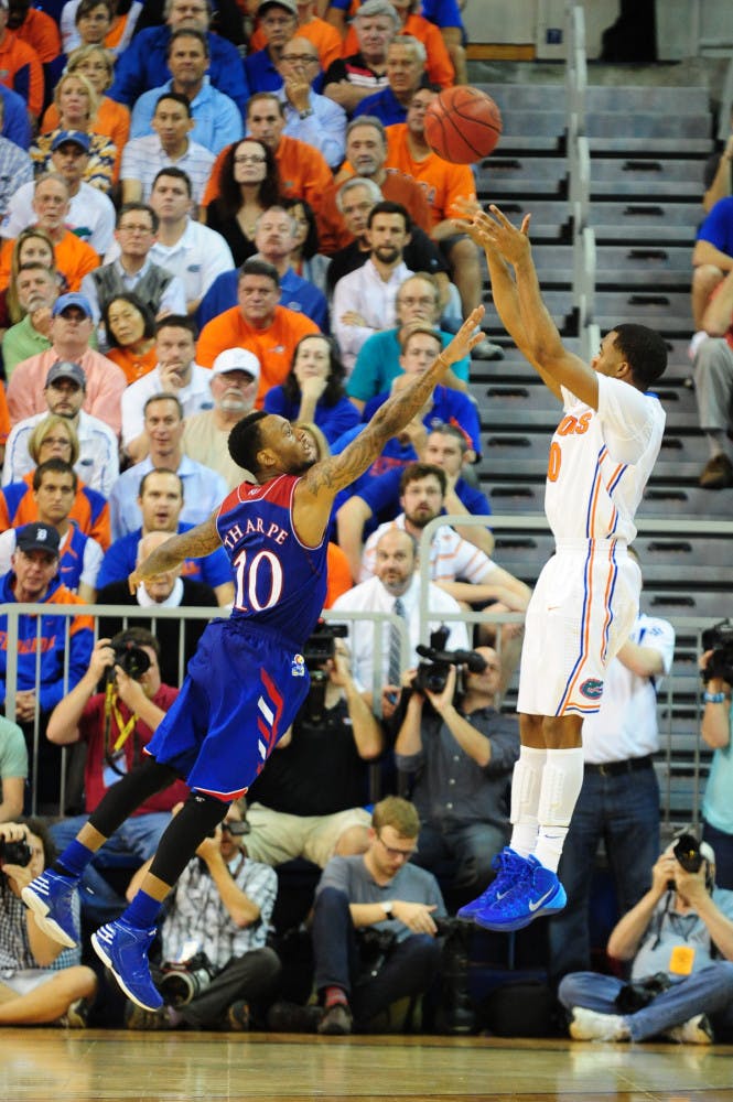 Florida point guard Kasey Hill shoots over Kansas guard Naadir Tharpe during No. 19 Florida's 67-61 win against No. 13 Kansas on Dec. 10 in the O'Connell Center.