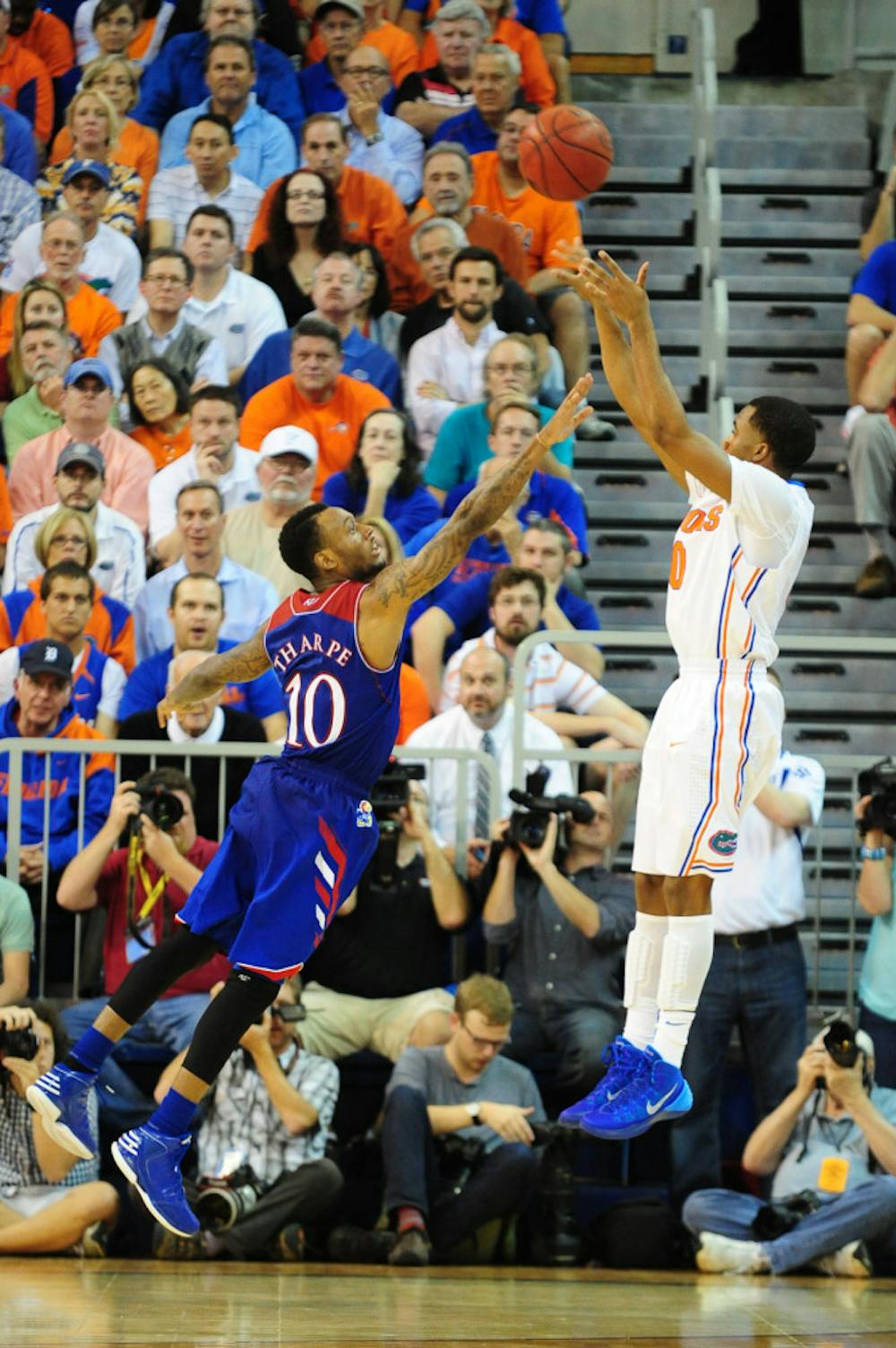 <p>Florida point guard Kasey Hill shoots over Kansas guard Naadir Tharpe during No. 19 Florida's 67-61 win against No. 13 Kansas on Dec. 10 in the O'Connell Center.</p>