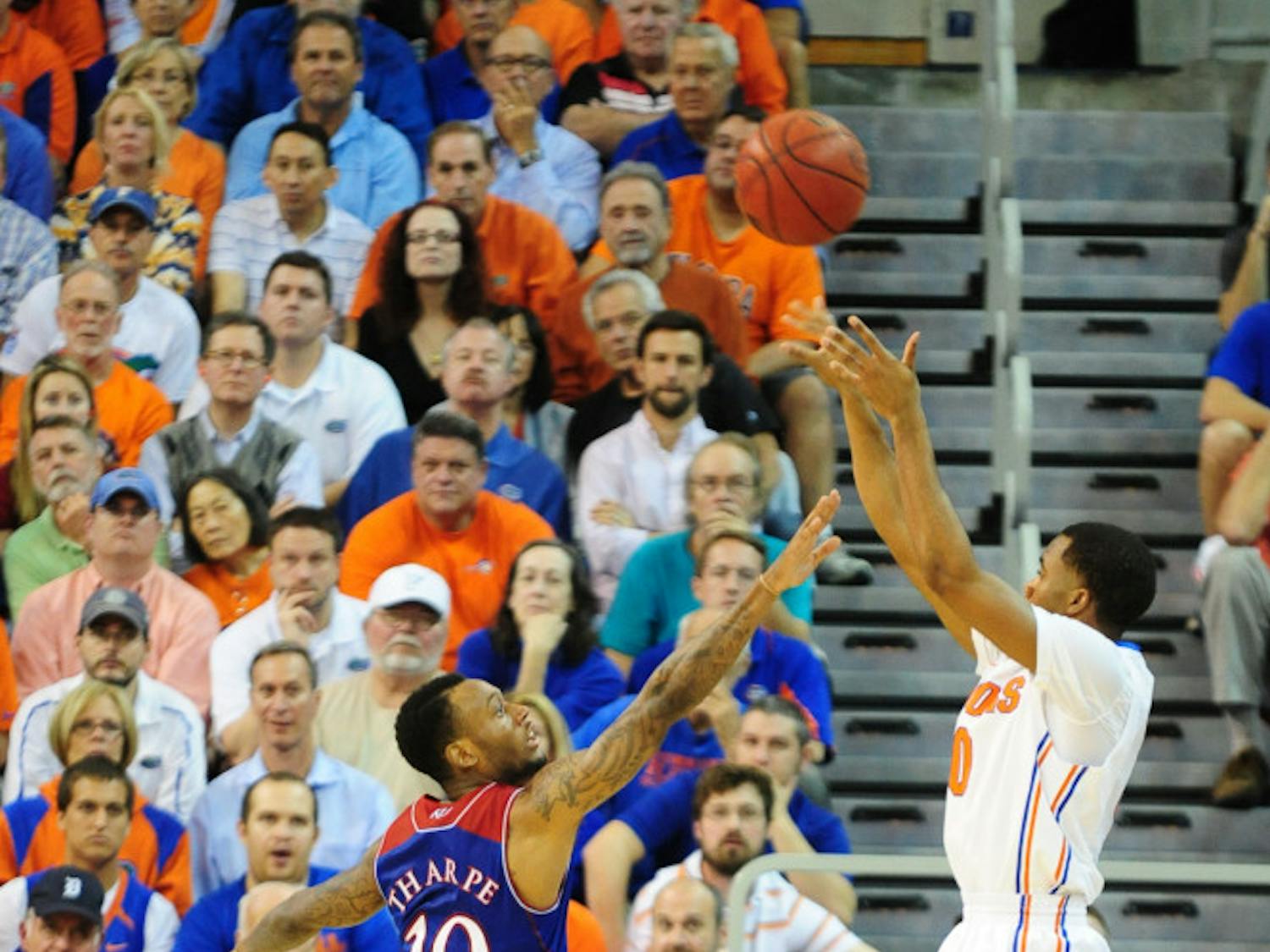 Florida point guard Kasey Hill shoots over Kansas guard Naadir Tharpe during No. 19 Florida's 67-61 win against No. 13 Kansas on Dec. 10 in the O'Connell Center.