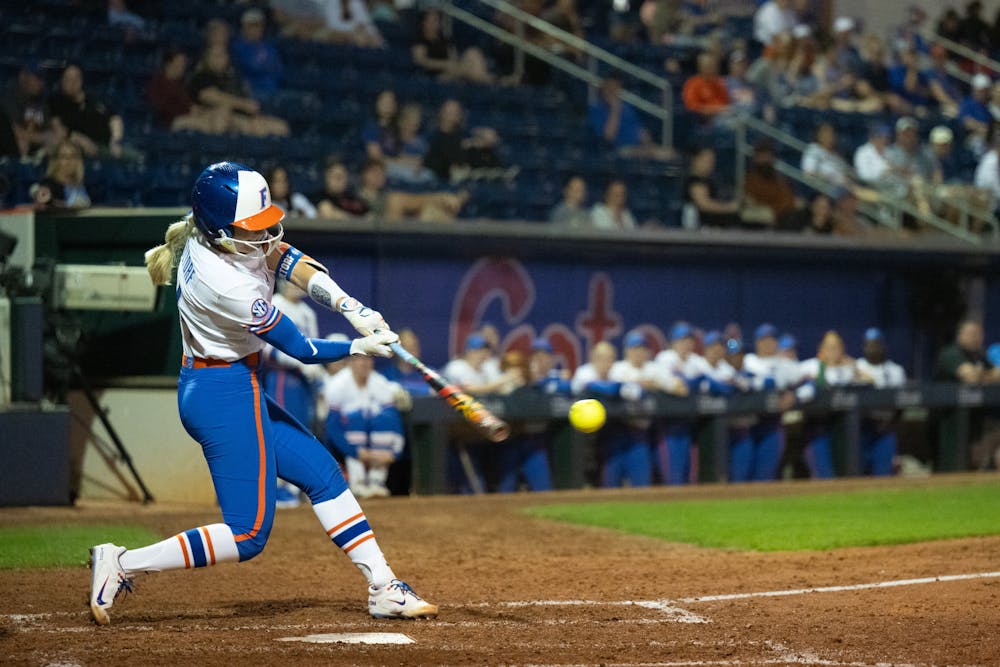 Florida Gators infielder Rylee Holtorf (4) hits the ball in a softball game against the Jacksonville Dolphins in Gainesville, Fla., on Tuesday, Feb. 11, 2025.