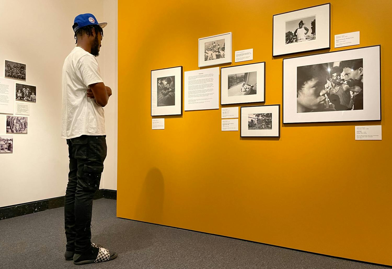 Dolce Douvert, a Gainesville resident looks at photographs in the Harn Museum of Art on Tuesday, July 27, 2021. The photos are part of a new exhibition called Shadow to Substance, which tells African American stories chronologically through historical imagery and modern imagery taken by today’s Black photographers.