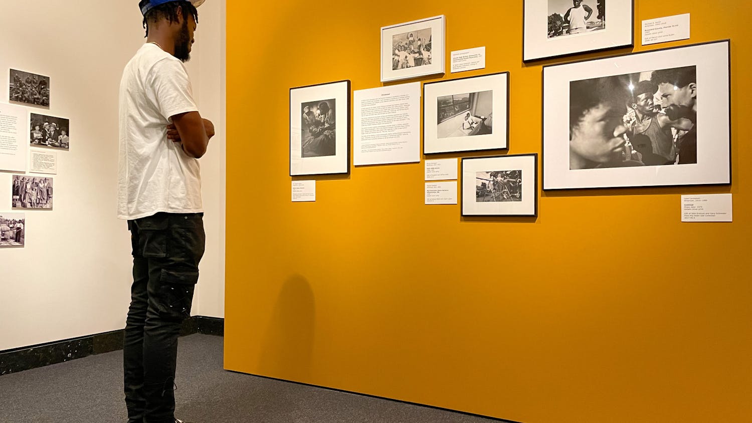 Dolce Douvert, a Gainesville resident looks at photographs in the Harn Museum of Art on Tuesday, July 27, 2021. The photos are part of a new exhibition called Shadow to Substance, which tells African American stories chronologically through historical imagery and modern imagery taken by today’s Black photographers.