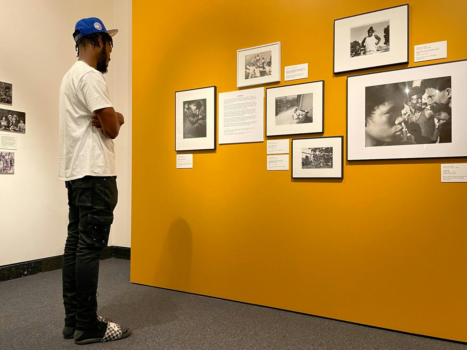 Dolce Douvert, a Gainesville resident looks at photographs in the Harn Museum of Art on Tuesday, July 27, 2021. The photos are part of a new exhibition called Shadow to Substance, which tells African American stories chronologically through historical imagery and modern imagery taken by today’s Black photographers.