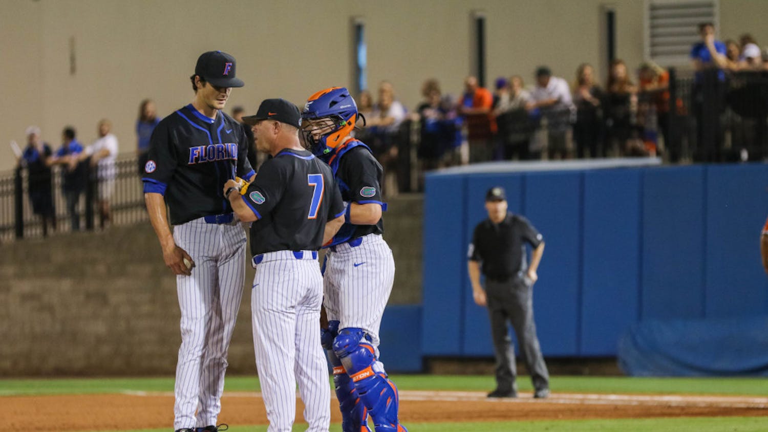 UF pitcher Tommy Mace (left) speaking with coach Kevin O’Sullivan (middle) and catcher Brady Smith (right) during the UM series last year.
