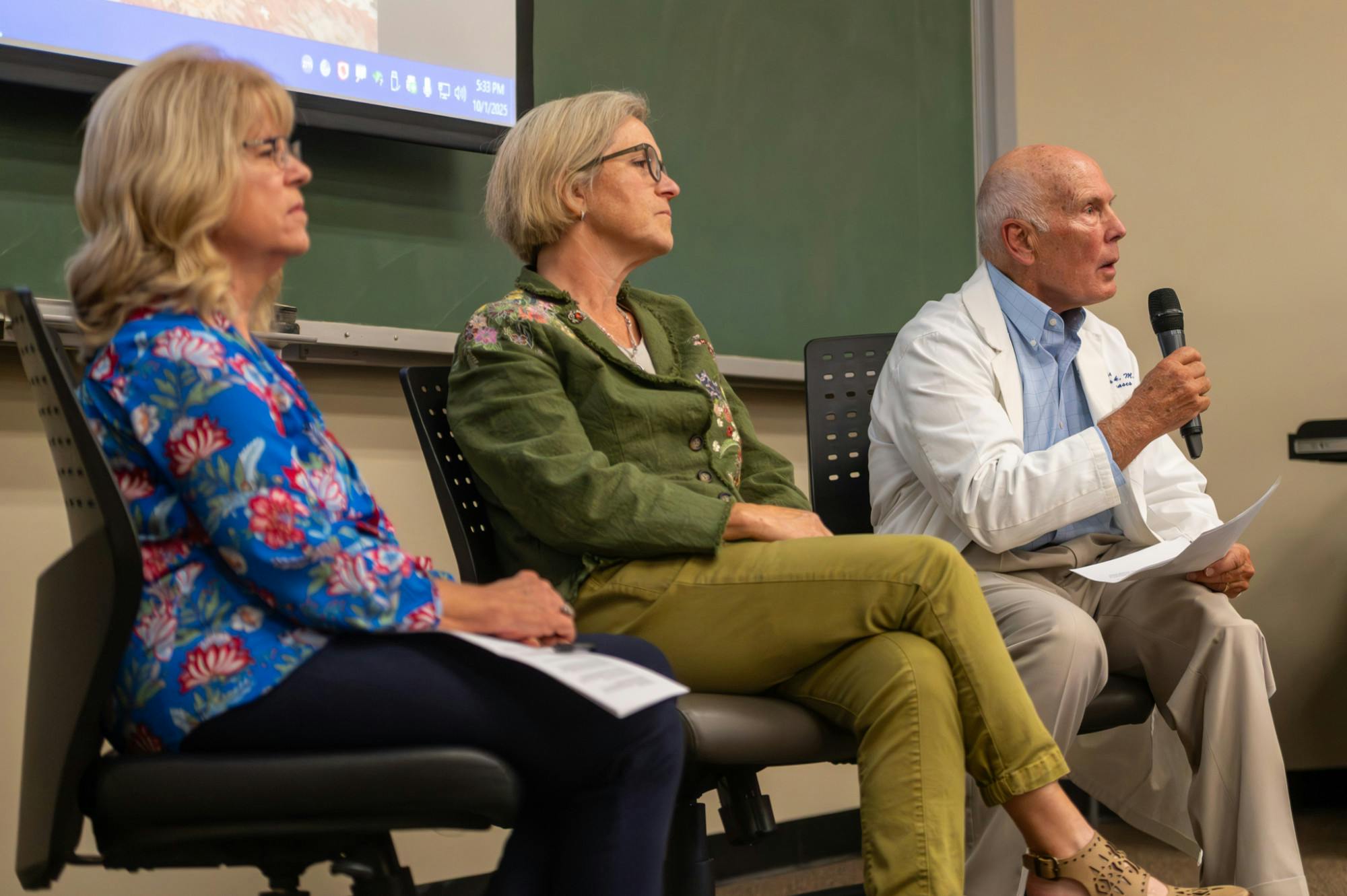 Dr. Frederick Southwick, along with  Dr. Kathleen Ryan and Dr. Catherine Boone, speak to University of Florida students about the benefits of vaccines at the UF Health Center Library on Oct. 1, 2025.