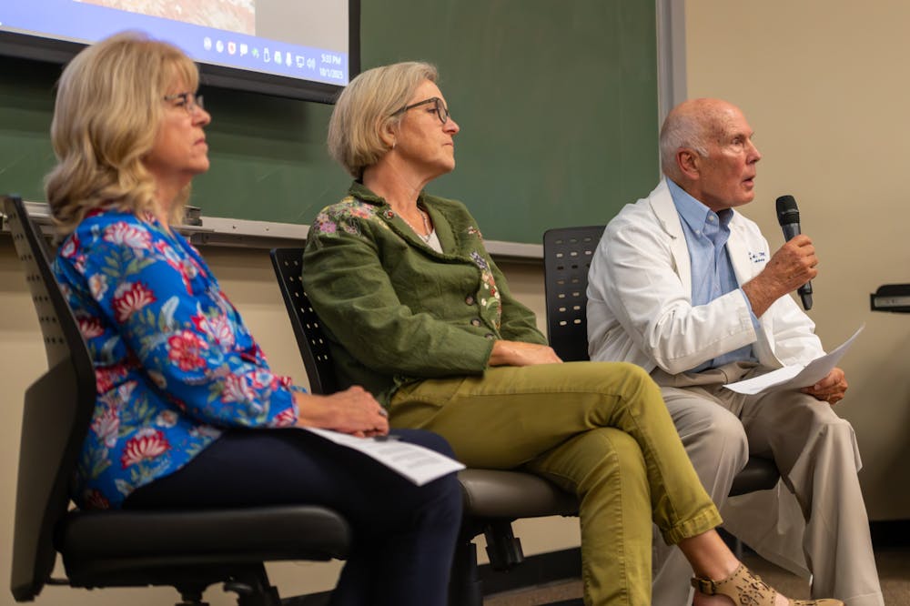 Dr. Frederick Southwick, along with  Dr. Kathleen Ryan and Dr. Catherine Boone, speak to University of Florida students about the benefits of vaccines at the UF Health Center Library on Oct. 1, 2025.