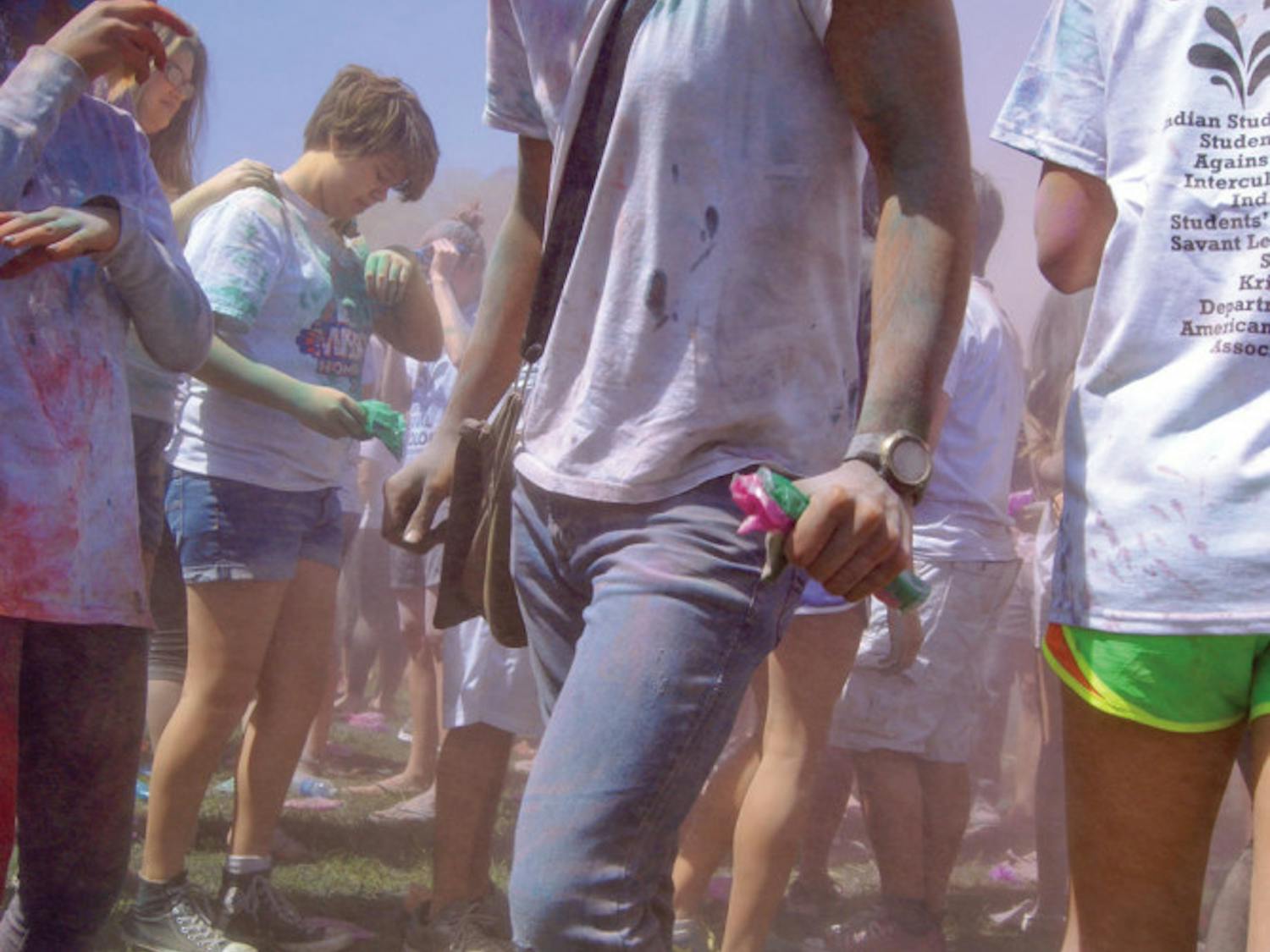 Dominique Lindsey-Gonzalez, a 19-year-old UF sustainability junior, dances during the UF Holi Festival of Colors on Hume Field on Saturday.