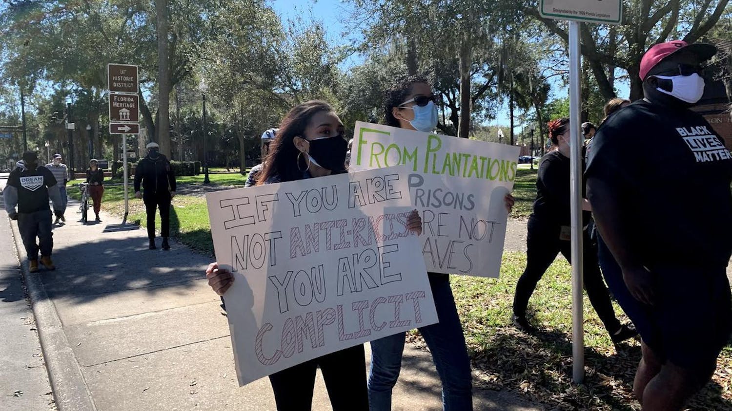 Brianna Alderman (Left) and Camile Hagins (Right) hold up homemade signs as they march in support of antiracism on Feb. 20, 2021.