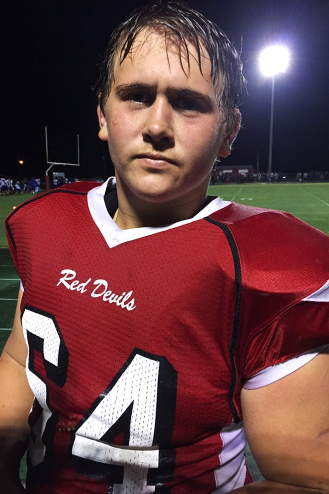 Stuart Bishop, 17, poses for a photo in his football uniform.