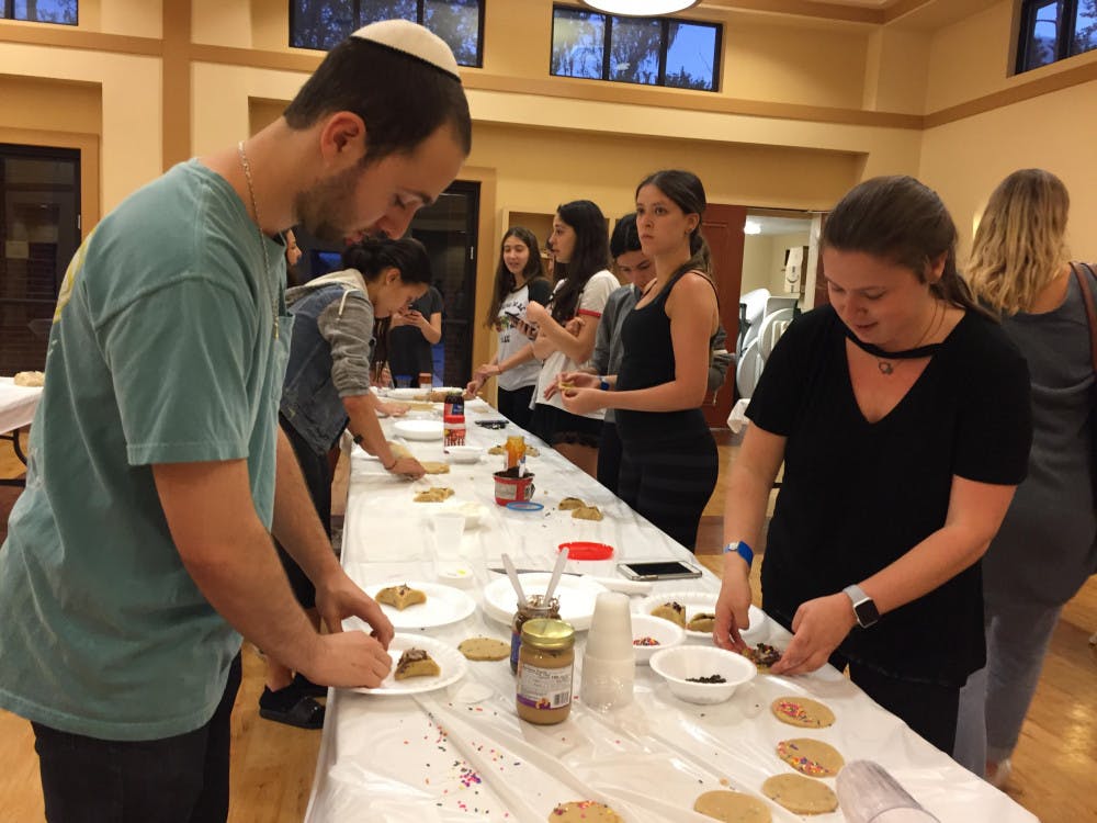 UF students make hamantaschen, Jewish triangular filled cookies, at a baking event hosted by the Lubavitch Chabad Jewish Center to raise money for Parkland shooting victims. 