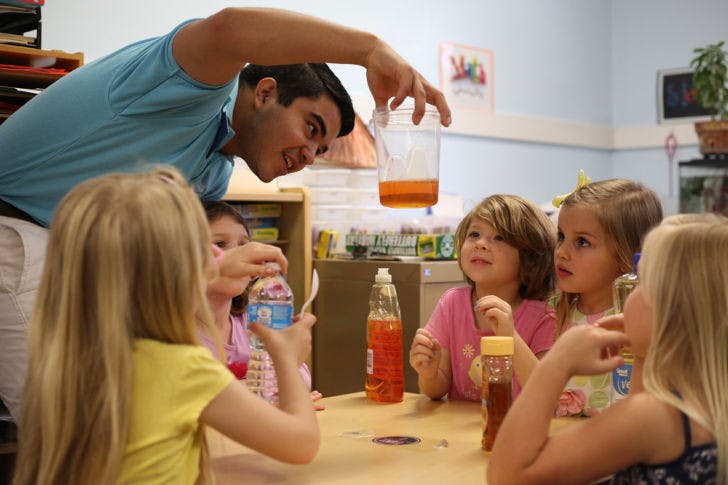 Engineering ambassador Fernando Barroso teaches Baby Gators about fluid density using soap, honey and water on Tuesday. EA and the American Institute of Aeronautics and Astronautics hosted an activity day at the preschool.