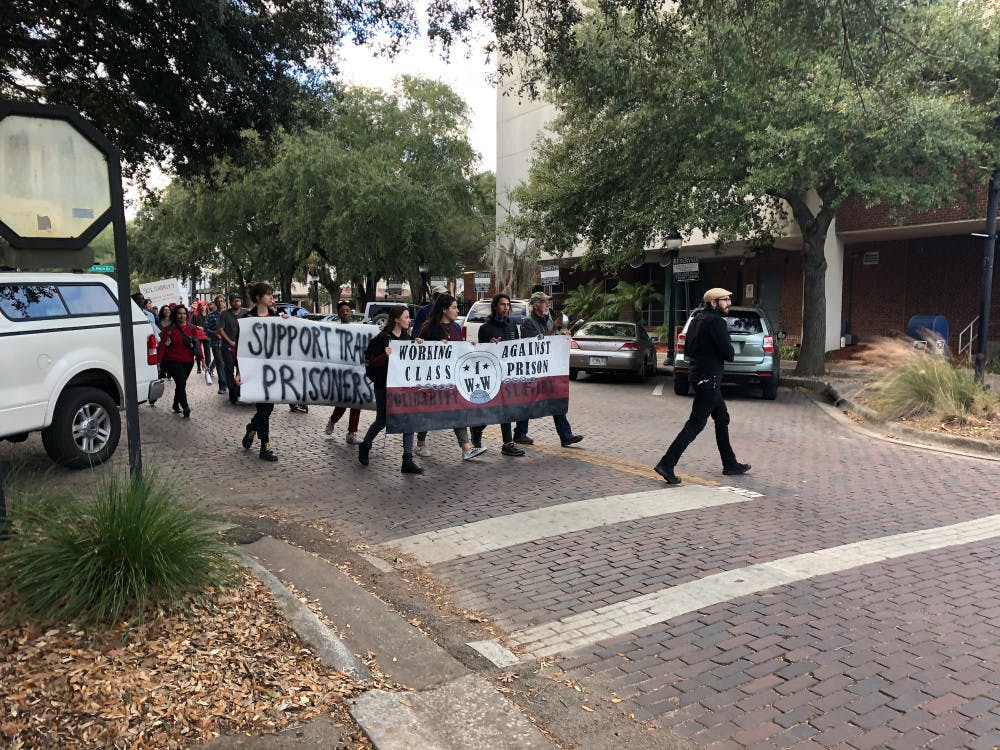 About 40 people marched from the Civic Meeting Center, at 433 S. Main St., to the County Commission Hearing at the Alachua County Administration Building, at 12 SE First St., to discuss the county’s contract for prison labor.