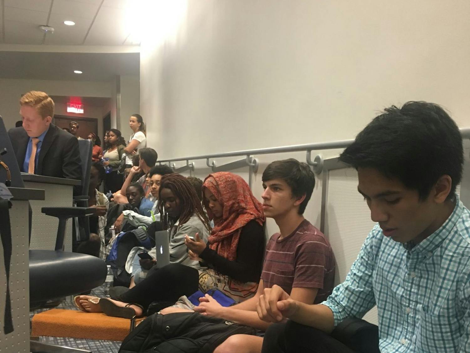 Students sit in at the Student Government Student Senate meeting on Tuesday. Although 43 students signed up for public debate, more students filled the chambers to object senators’ silence regarding the lack of funding for the Counseling &amp; Wellness Center and Richard Spencer’s visit to UF on Thursday.