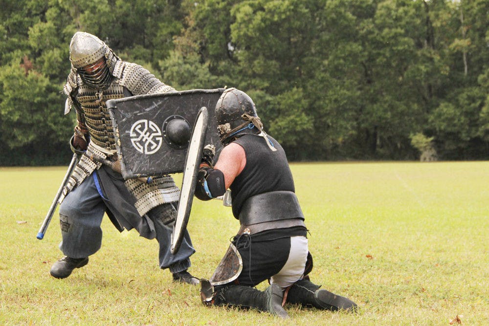 Subadai Baavgai attacks Tearlach Caitdhu during combat practice at Squirrel Ridge Park on Sunday. The two are members of the Society for Creative Anachronism, a historical reenactment group.