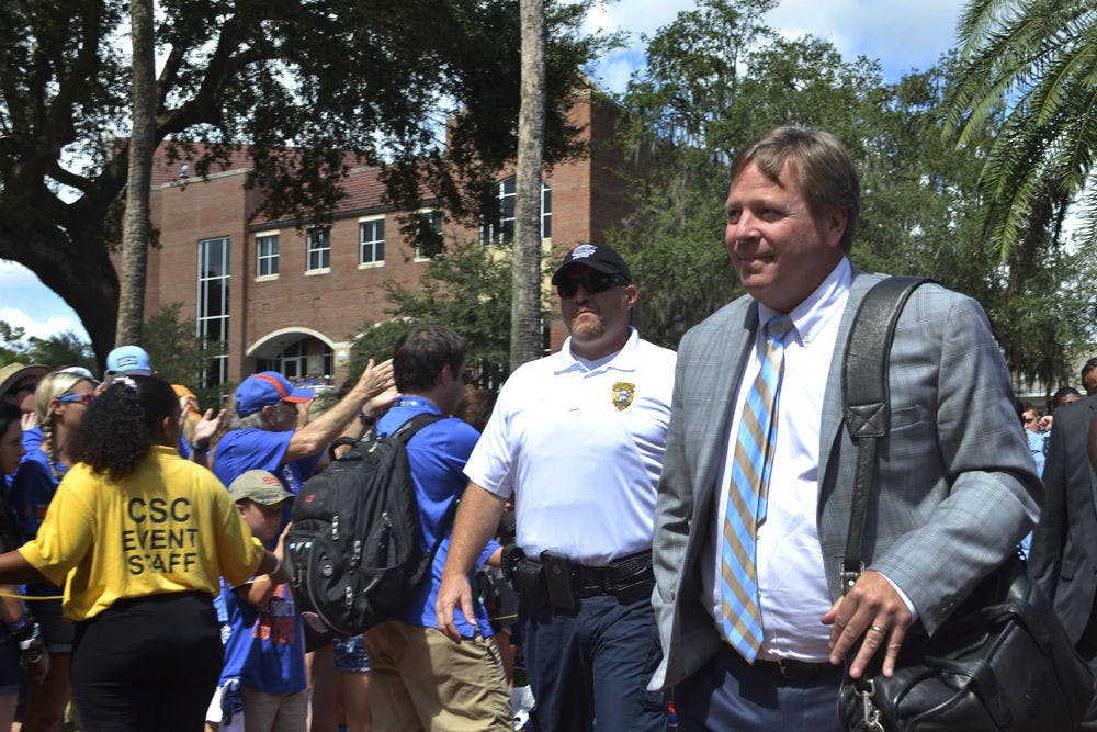 <p>UF coach Jim McElwain participates in UF's pre-game Gator Walk prior to Florida's 28-27 win against Tennessee.</p>