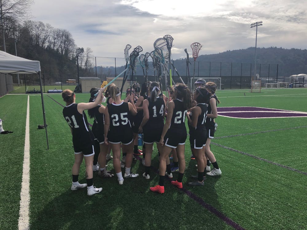 The team lifts their sticks in a group huddle. Photo credits to UP Women’s Club Lacrosse