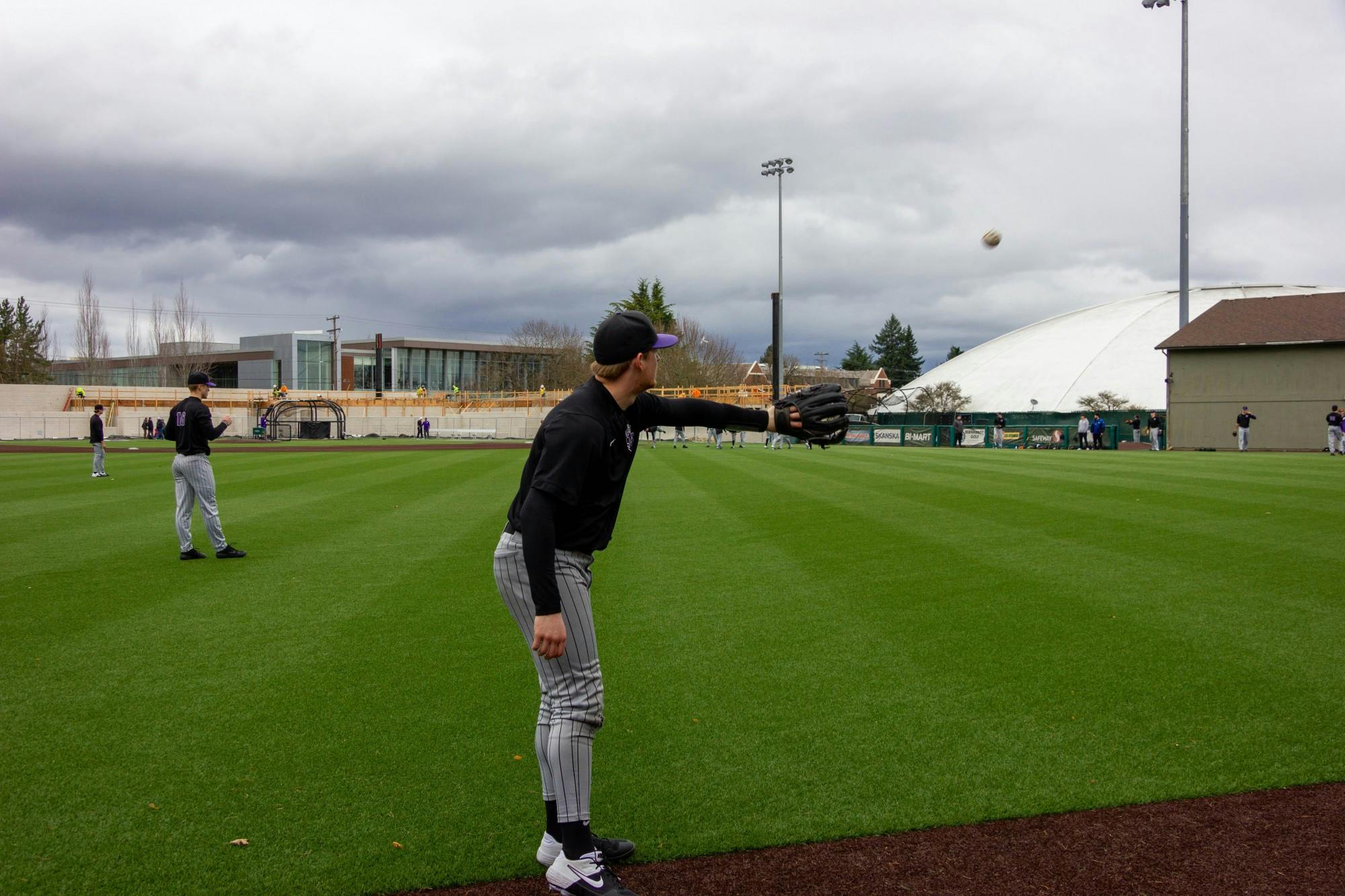 The baseball team warms up for a practice in February.