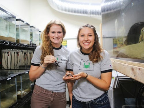  Seniors Katie Bates and Tai White-Toney hold crabs in their Swindell lab.Photo by Becca Tabor.