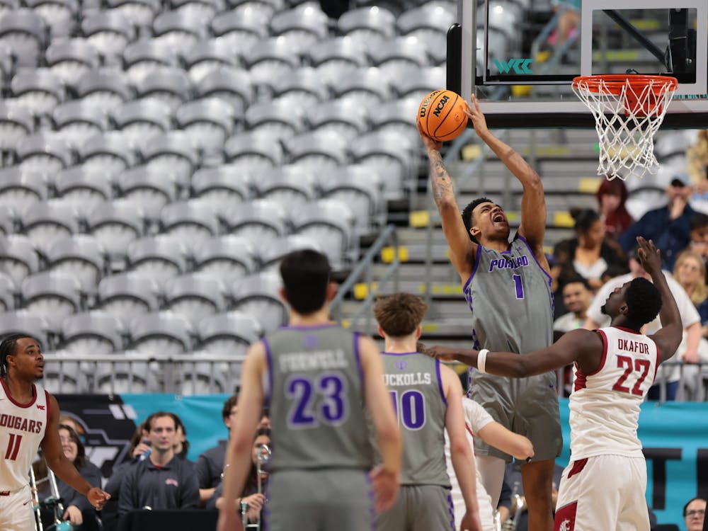 Senior center Jermaine Ballisager Webb fights through heavy defense from Washington State. Photo courtesy of Portland Pilots Digital Media.