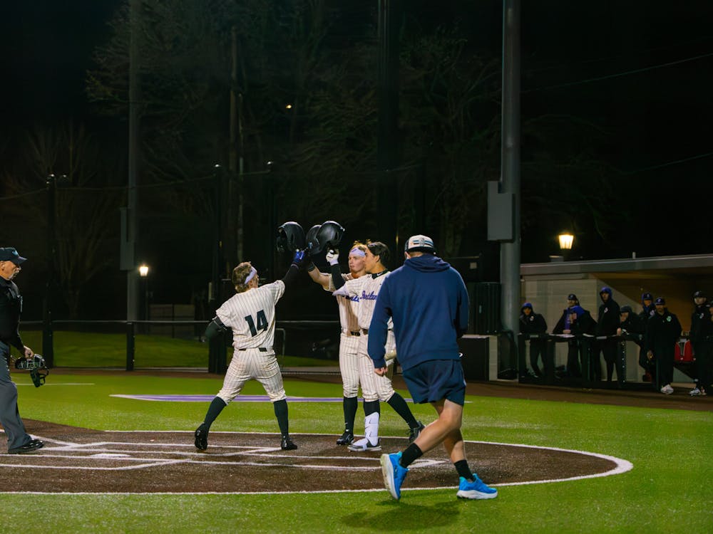 Infielder Jonas Salk crosses home after a two-run blast and celebrates with infielders Nolan Miller and Cole Katayama-Stall.
