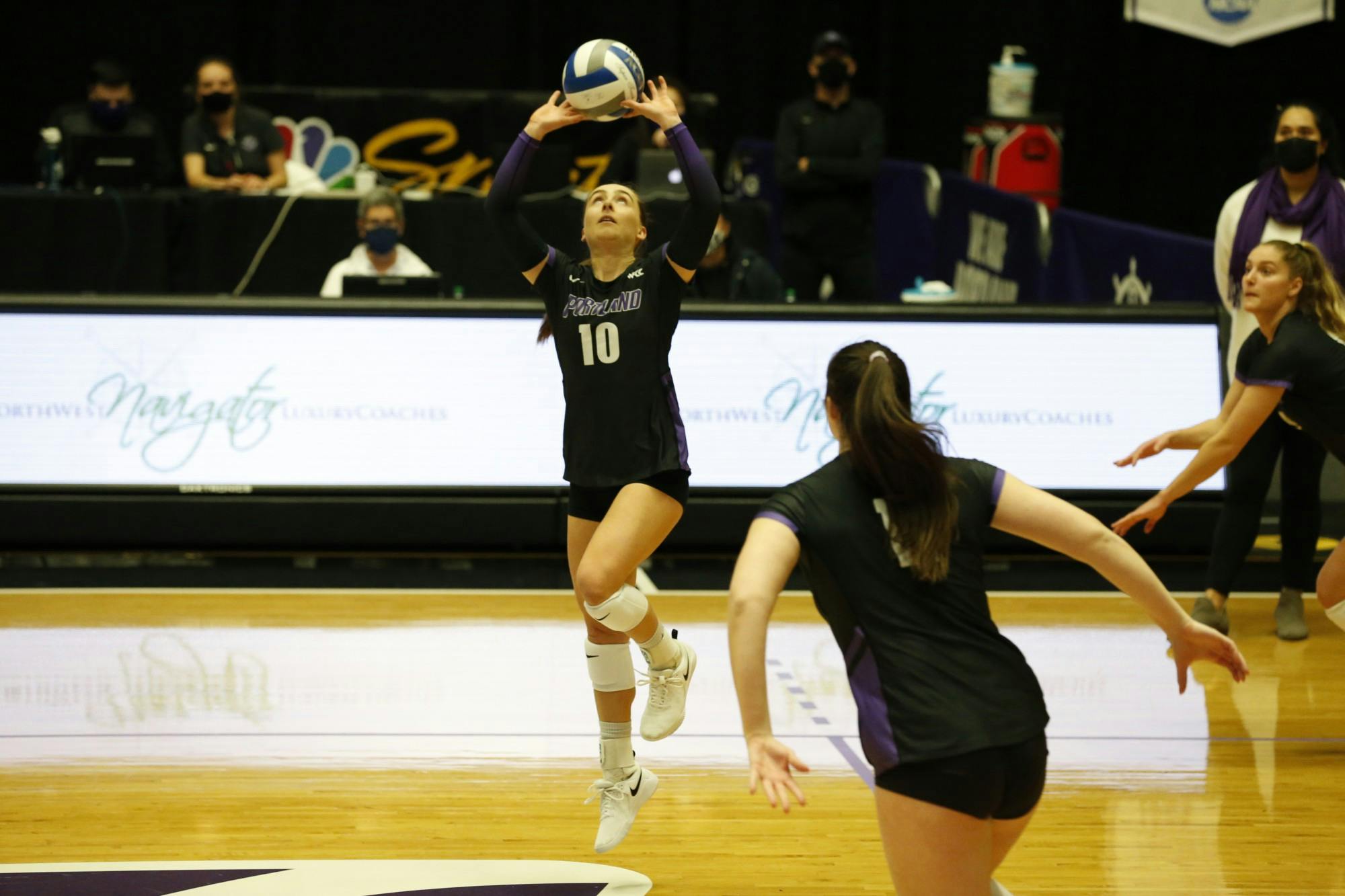 Senior Kellie Hughes setting the ball.Media Credit: University of Portland Athletics 