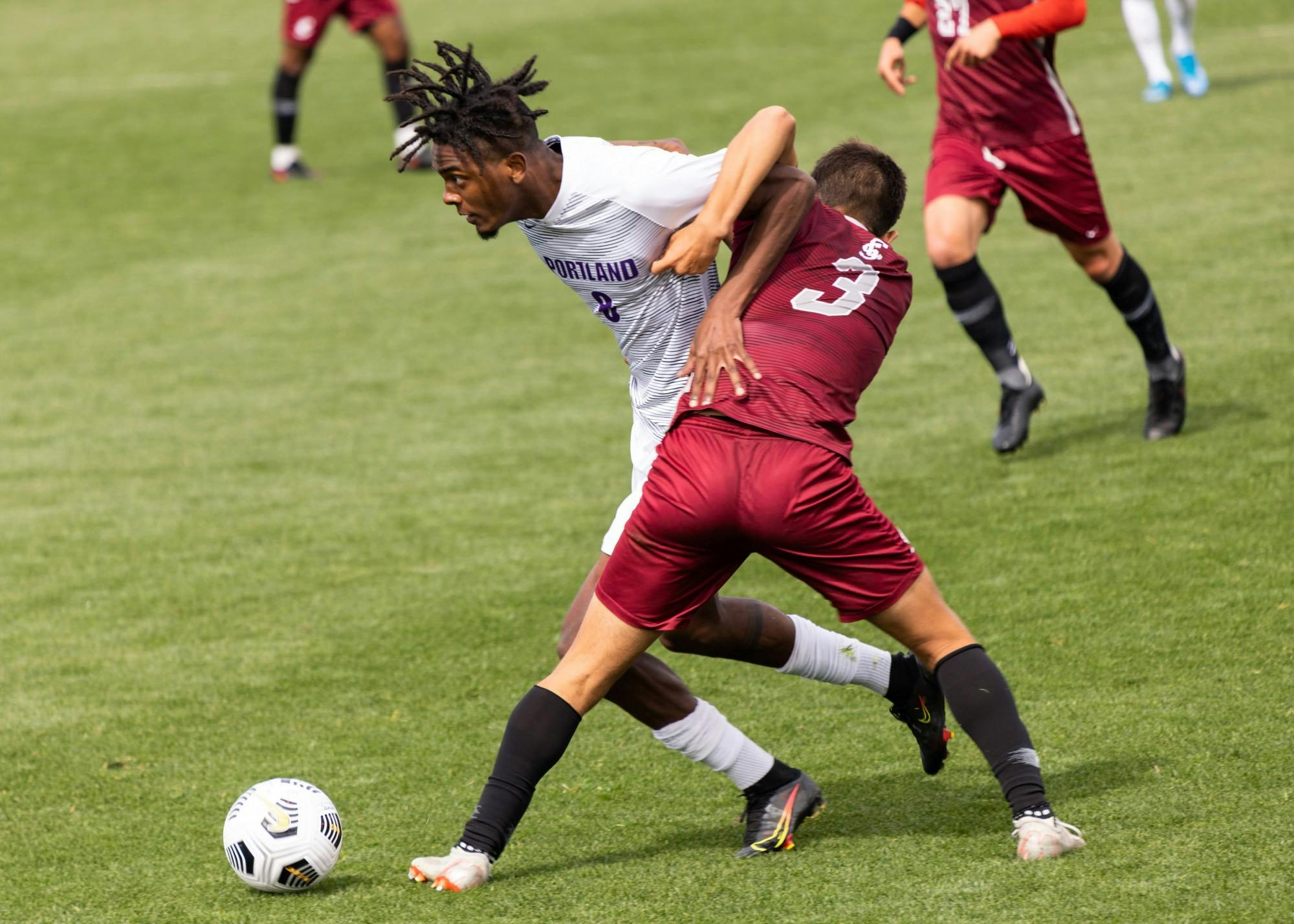 Midfielder Miles Robinson fights for the ball.
