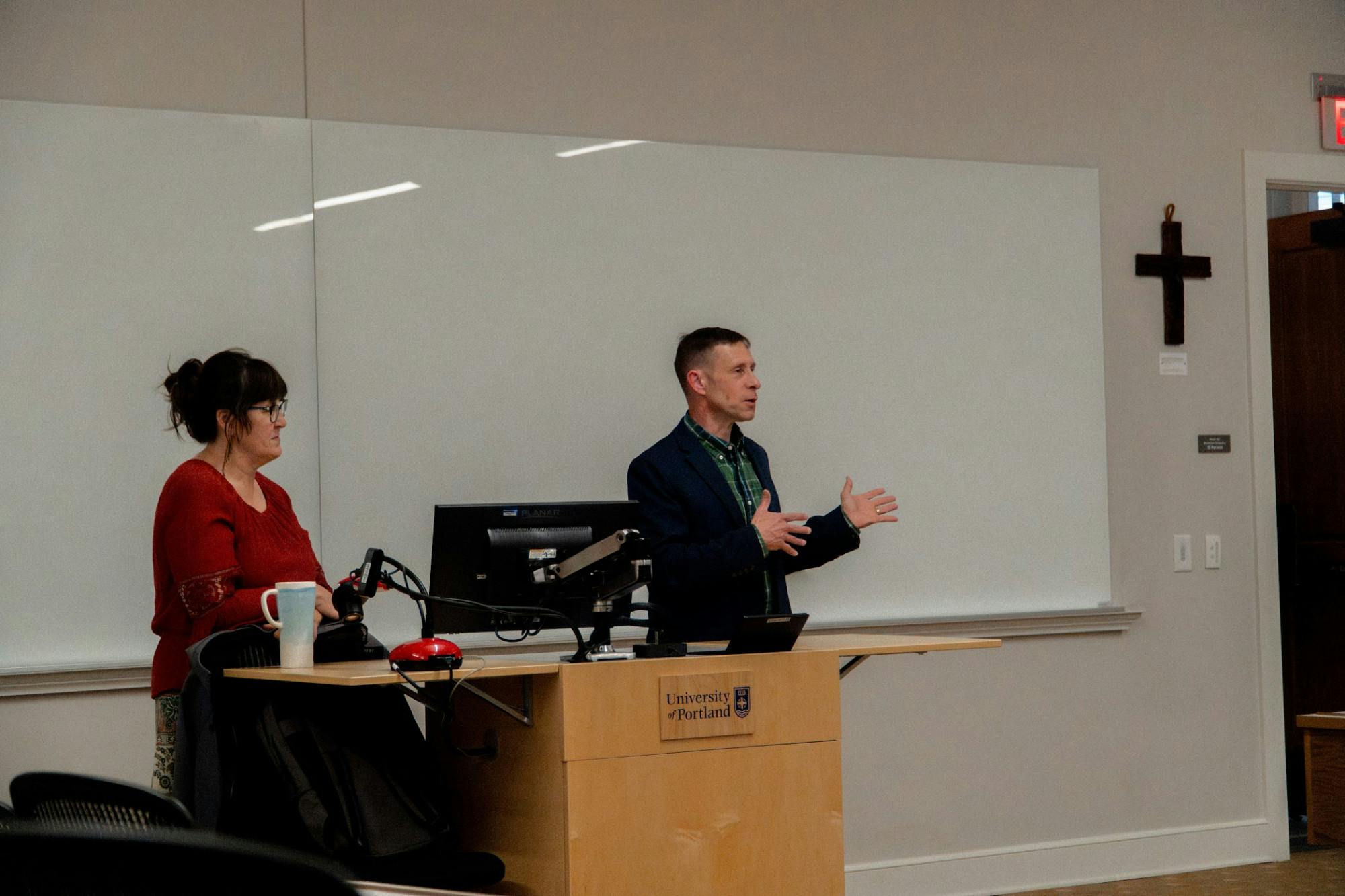 Anne Santiago (left) and John Zavage (right) answer student questions during a Q&A session to discuss "Operation Epic Fury.”