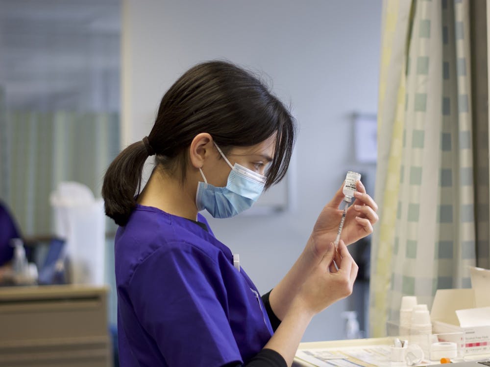 A nursing student prepares a syringe in the Simulation Lab located in Buckley Center.
