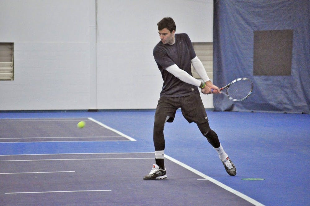  Senior Alex Ferrero takes a swing during practice. Photo by Kristen Garcia