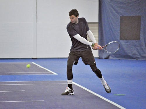  Senior Alex Ferrero takes a swing during practice. Photo by Kristen Garcia