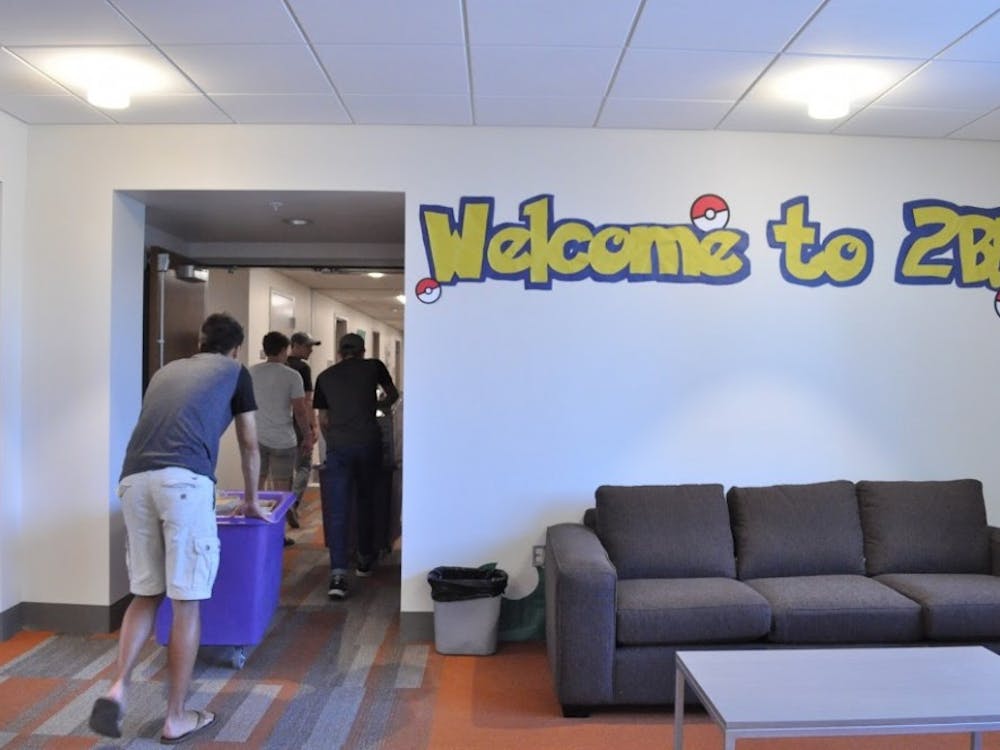 Students pass by a lounge area as they head toward their new&nbsp;dorm room in Lund Family Hall.