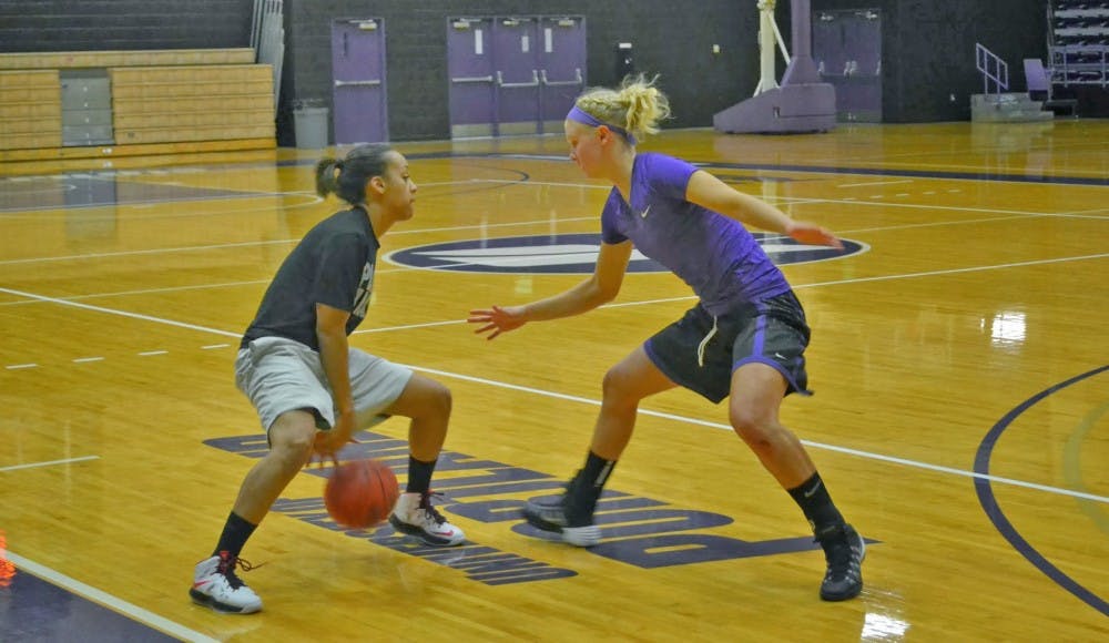  Sophomore guard Jazmyn Johnson dribbles around teammate freshman guard Hannah Mattson.