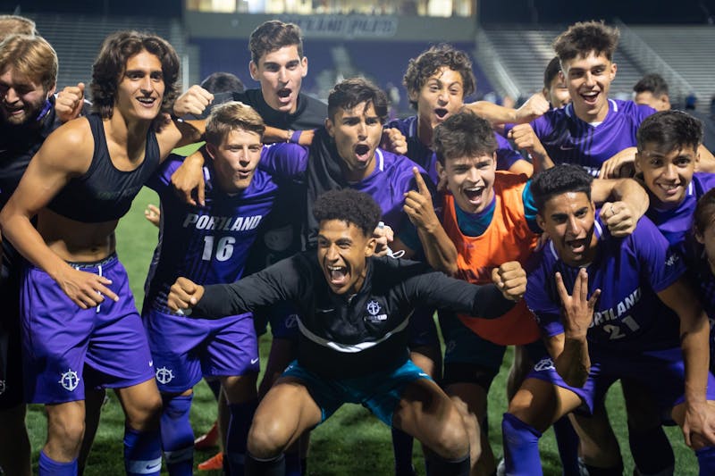 The men's team celebrates with their fans in front of the student section after the game. The final score was 2-0 for the Pilots.
