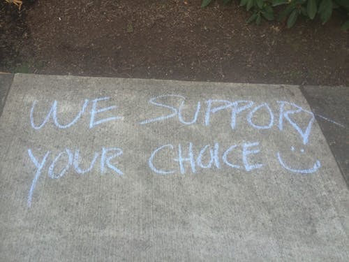  After Voice for Life wrote anti-abortion messages in chalk to spark dialogue, students in favor of abortion rights responded with their own chalk messages. Photo by McKena Miyashiro
